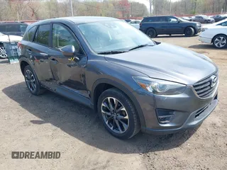 2016 Mazda CX-5 Grand Touring z VIN JM3KE4DY1G0893119, wystawiony jako IAAI lot #42049614 z przebiegiem 102 506 mil mil oraz . Historia ofert i sprzedaży dostępna na DreamBid. Obrazek 1.