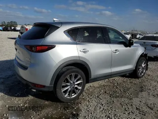 2021 Mazda CX-5 Grand Touring with VIN JM3KFADM8M1339008, listed as a Copart auction lot 49150115 with 144,851 mi miles and Salvage Title. Bid and sale history available at carsss.com. Image 3.