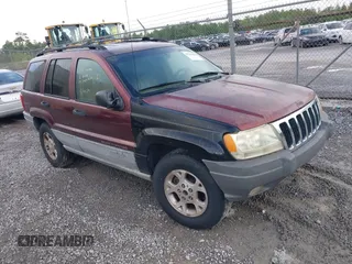2000 Jeep Grand Cherokee Laredo z VIN 1J4G248S0YC351033, wystawiony jako IAAI lot #42165830 z przebiegiem 145 351 mil mil oraz . Historia ofert i sprzedaży dostępna na DreamBid. Obrazek 1.