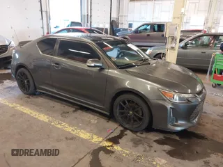 2014 Scion tC with VIN JTKJF5C77E3069906, listed as a IAAI auction lot 41243445 with 128,791 mi miles. Bid and sale history available at carsss.com. Image 1.