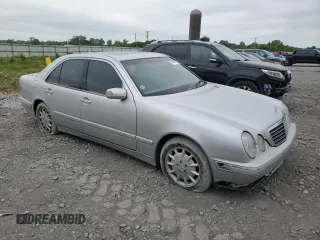2000 Mercedes-Benz E 320 with VIN WDBJF65J1YB099417, listed as a Copart auction lot 54656915 with 130,387 mi miles and Salvage Title. Bid and sale history available at DreamBid. Image 4.