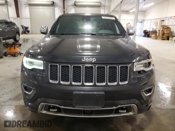 2015 Jeep Grand Cherokee Overland with VIN 1C4RJFCG7FC911899, listed as a Copart auction lot 54123925 with 243,031 mi miles and Salvage Title. Bid and sale history available at carsss.com. Image 5.