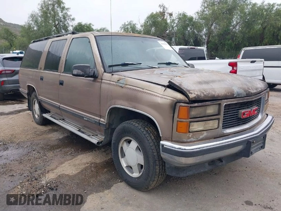 1995 GMC Suburban z VIN 1GKFK16K5SJ723038, wystawiony jako IAAI lot #41904397 z przebiegiem 142 082 mil mil oraz . Historia ofert i sprzedaży dostępna na DreamBid. Obrazek 1.
