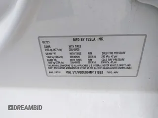 2021 Tesla Model Y Standard Range with VIN 5YJYGDED9MF121828, listed as a IAAI auction lot 42119518 with 34,454 mi miles and . Bid and sale history available at carsss.com. Image 9.