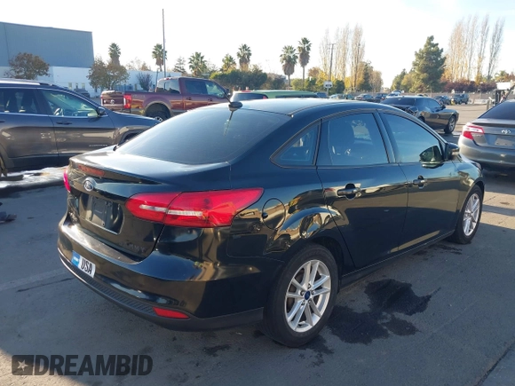2015 Ford Focus SE with VIN 1FADP3F29FL350473, listed as a IAAI auction lot 41032182 with 102,898 mi miles. Bid and sale history available at carsss.com. Image 4.