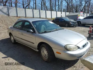 1999 Mercury Sable LS z VIN 1MEFM53S7XA622932, wystawiony jako IAAI lot #41708531 z przebiegiem 155 702 mil mil oraz . Historia ofert i sprzedaży dostępna na DreamBid. Obrazek 1.