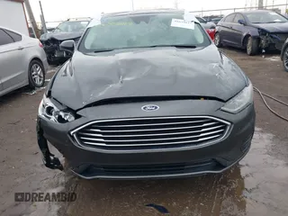 2020 Ford Fusion SE z VIN 3FA6P0LU6LR185721, wystawiony jako IAAI lot #41639827 z przebiegiem 63 857 mil mil oraz . Historia ofert i sprzedaży dostępna na DreamBid. Obrazek 12.