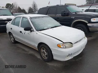 1999 Hyundai Accent z VIN KMHVF24N1XU583604, wystawiony jako IAAI lot #41613240 z przebiegiem 163 938 mil mil oraz . Historia ofert i sprzedaży dostępna na DreamBid. Obrazek 1.