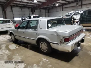 1989 Dodge Dynasty z VIN 1B3BC4634KD442902, wystawiony jako Copart lot #85151394 z przebiegiem 63 120 mil mil oraz Czysty tytuł • Clean title. Historia ofert i sprzedaży dostępna na DreamBid. Obrazek 2.