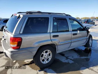 1999 Jeep Grand Cherokee Laredo with VIN 1J4GW58NXXC776438, listed as a Copart auction lot 84412044 with 163,060 mi miles and Salvage title. Bid and sale history available at DreamBid. Image 3.