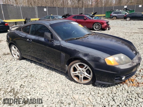 2003 Hyundai Tiburon GT z VIN KMHHN65F13U084620, wystawiony jako Copart lot #46880185 z przebiegiem Nie podano mil oraz Nie do naprawy • Non repairable. Historia ofert i sprzedaży dostępna na DreamBid. Obrazek 4.