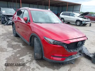 2018 Mazda CX-5 Grand Touring z VIN JM3KFADM4J1469704, wystawiony jako IAAI lot #42096387 z przebiegiem 89 170 mil mil oraz . Historia ofert i sprzedaży dostępna na DreamBid. Obrazek 1.