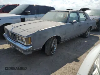 1987 Oldsmobile Cutlass z VIN 2G3GM51Y1H2347545, wystawiony jako Copart lot #76087594 z przebiegiem 98 257 mil mil oraz Szkody całkowita. Historia ofert i sprzedaży dostępna na DreamBid. Obrazek 1.