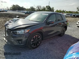 2016 Mazda CX-5 Grand Touring z VIN JM3KE2DY4G0878912, wystawiony jako Copart lot #56107285 z przebiegiem 107 750 mil mil oraz Szkoda całkowita • Salvage title. Historia ofert i sprzedaży dostępna na DreamBid. Obrazek 1.