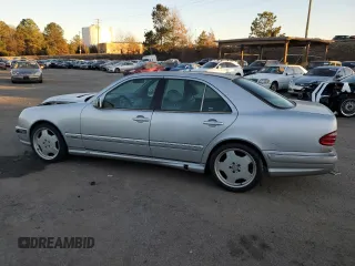 2000 Mercedes-Benz E-Class with VIN WDBJF70JXYB113988, listed as a Copart auction lot 86325514 with 198,321 mi miles and Salvage Title. Bid and sale history available at carsss.com. Image 2.
