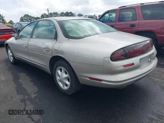 1997 Oldsmobile Aurora z VIN 1G3GR62CXV4121200, wystawiony jako IAAI lot #42277003 z przebiegiem 198 048 mil mil oraz . Historia ofert i sprzedaży dostępna na DreamBid. Obrazek 3.