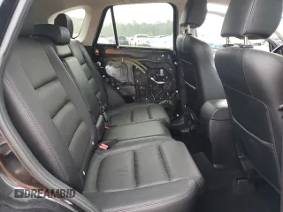 2016 Mazda CX-5 Grand Touring z VIN JM3KE2DY5G0676290, wystawiony jako Copart lot #54155325 z przebiegiem 124 743 mil mil oraz Szkoda całkowita • Salvage title. Historia ofert i sprzedaży dostępna na DreamBid. Obrazek 11.