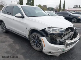 2018 BMW X5 xDrive40e iPerformance with VIN 5UXKT0C58J0V99415, listed as a IAAI auction lot 41391474 with 124,671 mi miles. Bid and sale history available at carsss.com. Image 1.