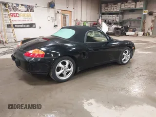 1999 Porsche Boxster z VIN WP0CA2984XU622814, wystawiony jako IAAI lot #42234977 z przebiegiem 52 404 mil mil oraz . Historia ofert i sprzedaży dostępna na DreamBid. Obrazek 4.