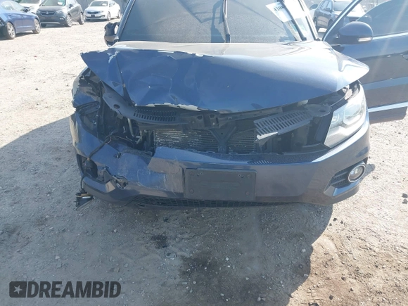 2014 Volkswagen Tiguan S z VIN WVGBV3AX7EW545538, wystawiony jako IAAI lot #42083281 z przebiegiem 129 227 mil mil oraz . Historia ofert i sprzedaży dostępna na DreamBid. Obrazek 6.