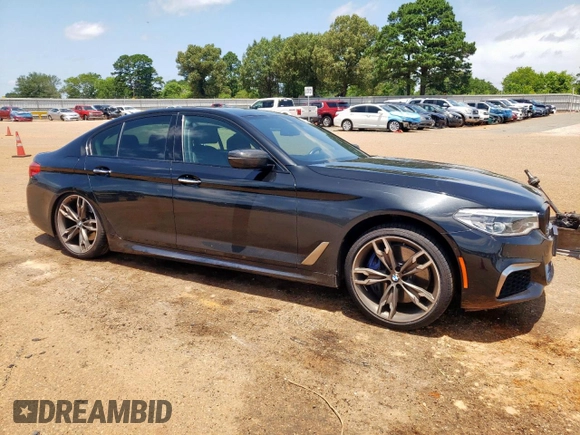 2018 BMW 5 Series M550i xDrive with VIN WBAJB9C54JB286450, listed as a Copart auction lot 61232125 with 88,479 mi miles and Salvage title. Bid and sale history available at DreamBid. Image 4.