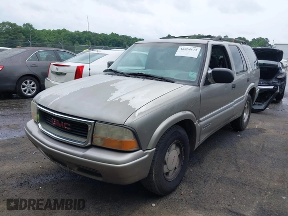 1999 GMC Jimmy SLE z VIN 1GKCS13W0X2512048, wystawiony jako IAAI lot #42364175 z przebiegiem 195 301 mil mil oraz . Historia ofert i sprzedaży dostępna na DreamBid. Obrazek 2.