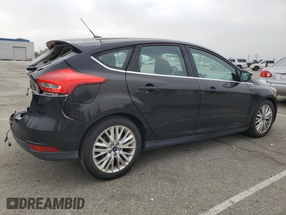 2015 Ford Focus Titanium z VIN 1FADP3N25FL324390, wystawiony jako Copart lot #59801805 z przebiegiem 97 615 mil mil oraz Szkoda całkowita • Salvage title. Historia ofert i sprzedaży dostępna na DreamBid. Obrazek 3.