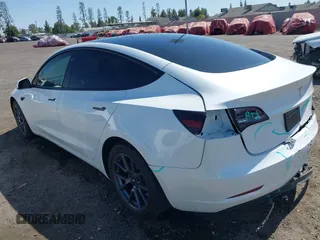 2023 Tesla Model 3 z VIN 5YJ3E1EA5PF517893, wystawiony jako IAAI lot #42515181 z przebiegiem 38 538 mil mil oraz . Historia ofert i sprzedaży dostępna na DreamBid. Obrazek 3.