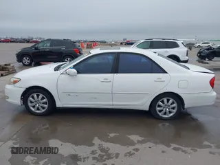 2003 Toyota Camry LE z VIN JTDBF30K530148403, wystawiony jako IAAI lot #41688346 z przebiegiem 299 143 mil mil oraz . Historia ofert i sprzedaży dostępna na DreamBid. Obrazek 14.