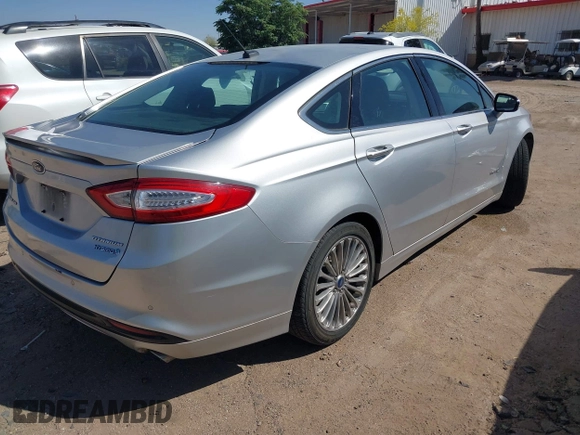 2014 Ford Fusion Titanium Hybrid with VIN 3FA6P0RUXER103516, listed as a IAAI auction lot 42004602 with 128,287 mi miles and . Bid and sale history available at carsss.com. Image 4.