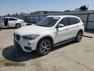 2018 BMW X1 xDrive28i with VIN WBXHT3C38J5L25259, listed as a Copart auction lot 61079965 with 76,681 mi miles and Salvage title. Bid and sale history available at DreamBid. Image 1.