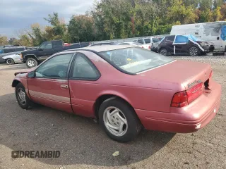 1996 Ford Thunderbird LX with VIN 1FALP62W7TH135632, listed as a Copart auction lot 77134024 with 128,931 mi miles and Salvage Title. Bid and sale history available at DreamBid. Image 2.