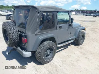 2002 Jeep Wrangler Sport z VIN 1J4FA49S62P731507, wystawiony jako IAAI lot #42584222 z przebiegiem 206 661 mil mil oraz . Historia ofert i sprzedaży dostępna na DreamBid. Obrazek 4.