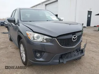 2014 Mazda CX-5 Touring z VIN JM3KE2CY6E0388292, wystawiony jako IAAI lot #41938958 z przebiegiem 91 621 mil mil oraz . Historia ofert i sprzedaży dostępna na DreamBid. Obrazek 1.