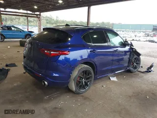 2021 Alfa Romeo Stelvio Ti with VIN ZASPAKBN4M7D21284, listed as a IAAI auction lot 40573443 with 26,230 mi miles. Bid and sale history available at carsss.com. Image 4.