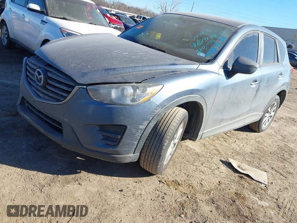 2016 Mazda CX-5 Sport with VIN JM3KE2BY3G0641895, listed as a IAAI auction lot 41689138 with 121,636 mi miles and . Bid and sale history available at DreamBid. Image 2.