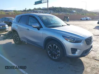 2016 Mazda CX-5 Grand Touring z VIN JM3KE2DY8G0709573, wystawiony jako IAAI lot #42021005 z przebiegiem 113 941 mil mil oraz . Historia ofert i sprzedaży dostępna na DreamBid. Obrazek 1.