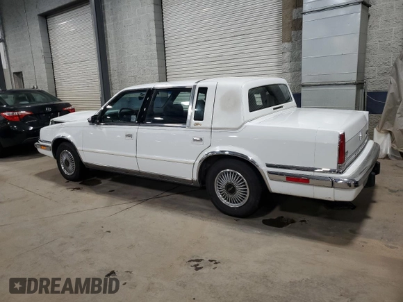 1991 Chrysler New Yorker z VIN 1C3XY66R1MD290977, wystawiony jako Copart lot #83359124 z przebiegiem 98 611 mil mil oraz Szkoda całkowita • Salvage title. Historia ofert i sprzedaży dostępna na DreamBid. Obrazek 2.
