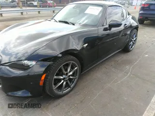 2021 Mazda MX-5 Miata Grand Touring z VIN JM1NDAM75M0451597, wystawiony jako IAAI lot #41932712 z przebiegiem 61 710 mil mil oraz . Historia ofert i sprzedaży dostępna na DreamBid. Obrazek 6.