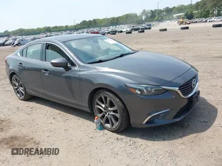 2016 Mazda 6 i Grand Touring z VIN JM1GJ1W54G1466412, wystawiony jako IAAI lot #42419863 z przebiegiem 117 878 mil mil oraz . Historia ofert i sprzedaży dostępna na DreamBid. Obrazek 1.