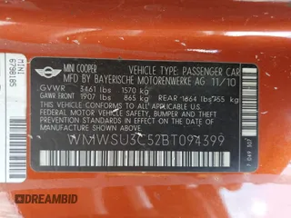 2011 MINI Hardtop with VIN WMWSU3C52BT094399, listed as a Copart auction lot 56561635 with 94,428 mi miles and Salvage Title. Bid and sale history available at DreamBid. Image 12.