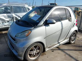 2009 Smart fortwo Pure with VIN WMEEJ31X09K301824, listed as a IAAI auction lot 42088793 with 51,948 mi miles. Bid and sale history available at carsss.com. Image 2.