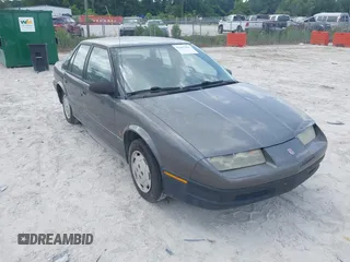 1994 Saturn SL z VIN 1G8ZF559XRZ190063, wystawiony jako IAAI lot #42467911 z przebiegiem 66 680 mil mil oraz . Historia ofert i sprzedaży dostępna na DreamBid. Obrazek 1.