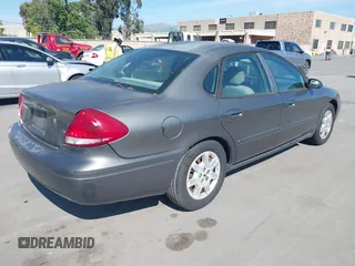 2005 Ford Taurus SE with VIN 1FAFP53U95A289971, listed as a IAAI auction lot 42143134 with 167,702 mi miles. Bid and sale history available at carsss.com. Image 4.