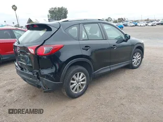 2016 Mazda CX-5 Sport with VIN JM3KE2BY4G0761933, listed as a IAAI auction lot 41709274 with 131,127 mi miles. Bid and sale history available at carsss.com. Image 4.