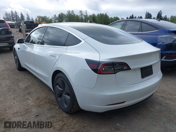 2020 Tesla Model 3 Standard Range Plus with VIN 5YJ3E1EA5LF613002, listed as a IAAI auction lot 42129085 with 55,672 mi miles. Bid and sale history available at carsss.com. Image 3.