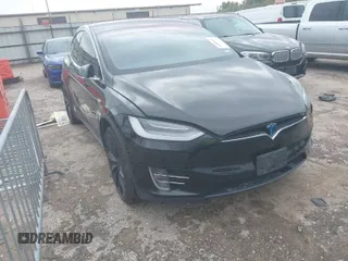 2021 Tesla Model X Long Range Plus with VIN 5YJXCAE27MF324270, listed as a IAAI auction lot 41886101 with 59,614 mi miles and . Bid and sale history available at carsss.com. Image 1.