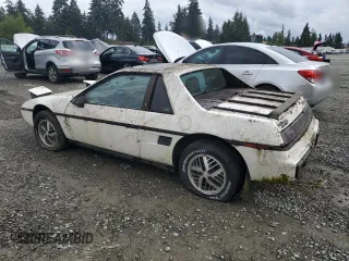 1984 Pontiac Fiero z VIN 1G2AF37R6EP320306, wystawiony jako Copart lot #68255394 z przebiegiem 49 284 mil mil oraz Tytuł czysty. Historia ofert i sprzedaży dostępna na DreamBid. Obrazek 2.