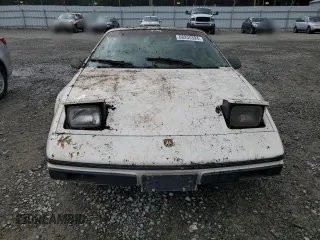 1984 Pontiac Fiero z VIN 1G2AF37R6EP320306, wystawiony jako Copart lot #68255394 z przebiegiem 49 284 mil mil oraz Tytuł czysty. Historia ofert i sprzedaży dostępna na DreamBid. Obrazek 5.