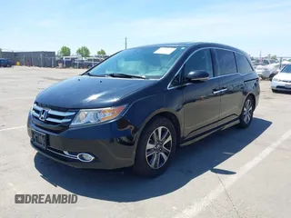 2014 Honda Odyssey Touring with VIN 5FNRL5H99EB133864, listed as a IAAI auction lot 42201359 with 122,490 mi miles and . Bid and sale history available at DreamBid. Image 2.